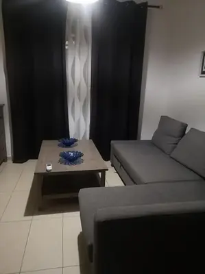 a living room with a couch and a coffee table at Crystal aptmnt next to the beach in Protaras