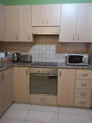 a kitchen with a stove and a microwave in it at Crystal aptmnt next to the beach in Protaras