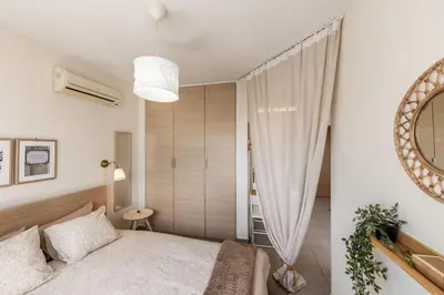 a bedroom with a bed and a large window at STAY Sunflower Delight Studio in Nicosia