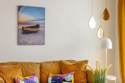 a living room with a couch and a picture of a boat at STAY Sunflower Delight Studio in Nicosia