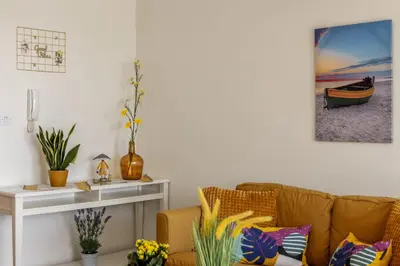 a living room with a couch and a table at STAY Sunflower Delight Studio in Nicosia