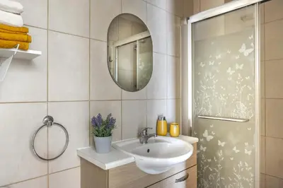 a bathroom with a sink and a mirror at STAY Sunflower Delight Studio in Nicosia