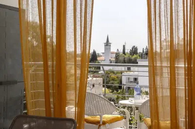 a balcony with a table and chairs and a window at STAY Sunflower Delight Studio in Nicosia