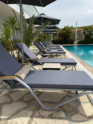 a row of lounge chairs next to a swimming pool at Cyprotel Florida in Ayia Napa