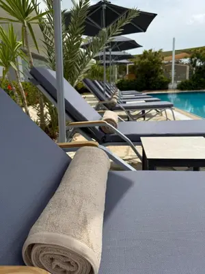 a towel is sitting on a table by a pool at Cyprotel Florida in Ayia Napa
