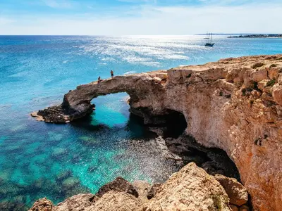 two people standing on a rock formation in the ocean at Cyprotel Florida in Ayia Napa