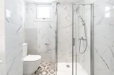 a bathroom with a shower and a toilet at Villa Elite Blu by Ezoria Villas in Ayia Napa