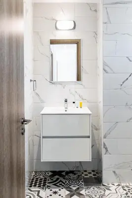 a white bathroom with a sink and a window at Villa Elite Blu by Ezoria Villas in Ayia Napa