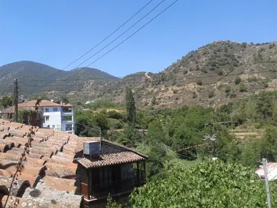 a view of a village with mountains in the background at Zangoulos Villa in Kakopetria