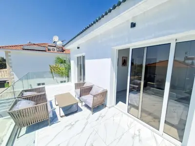 a patio with chairs and a table on a balcony at Sunshine Villa Ayia Napa in Ayia Napa