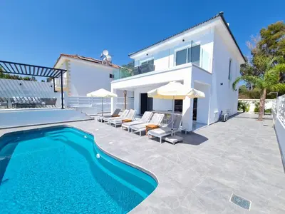 a villa with a swimming pool and a house at Sunshine Villa Ayia Napa in Ayia Napa