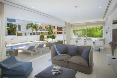 a living room with a couch and a pool at Goodness Villa offers Magnificent Coastal Views in Protaras