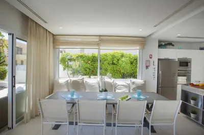 a kitchen and dining room with a table and chairs at Goodness Villa offers Magnificent Coastal Views in Protaras