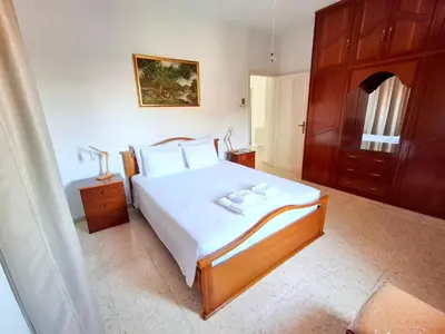 a bedroom with a large bed with two towels on it at Grandma's House in Liopetri