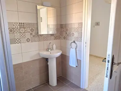 a bathroom with a sink and a mirror at Grandma's House in Liopetri
