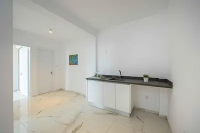 a white kitchen with a sink and a counter at Brand New Luxurious Villa With Pool in Protaras