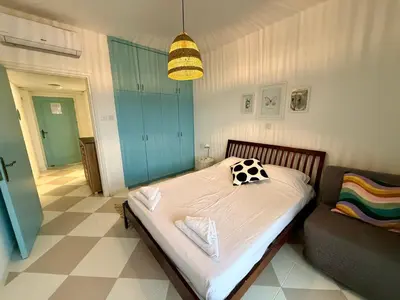 a small bedroom with a bed and a couch at Olivia One Bedroom Apt renovated 2026 in Paralimni