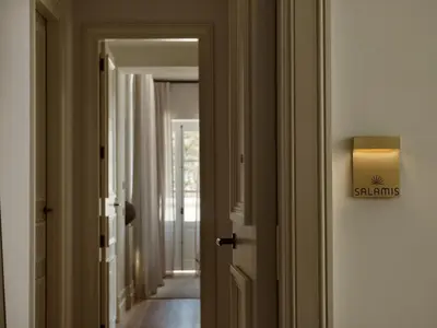 a hallway with a door with a sign on it at Amyth of Nicosia in Nicosia