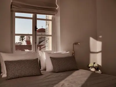 a bed with pillows and a window in a bedroom at Amyth of Nicosia in Nicosia