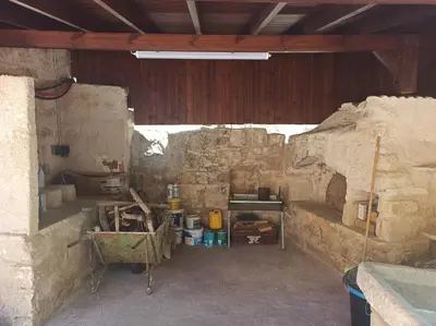 an inside view of a room in a stone building at Cottage in Anogyra in Anoyira