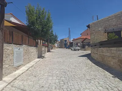 a cobblestone street in a town with buildings at Cottage in Anogyra in Anoyira