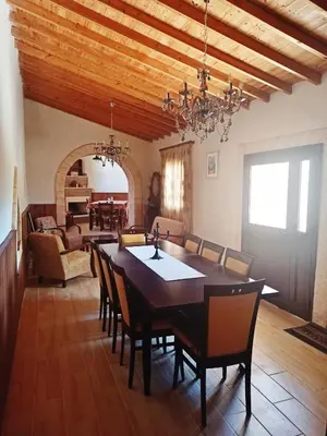 a dining room with a large table and chairs at Cottage in Anogyra in Anoyira