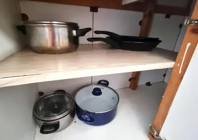 a shelf with a pot and pans on it at Boho Greek Haven with Orange Grove Views Near Beach in Larnaka