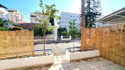 a fence with two trees in a courtyard at Boho Greek Haven with Orange Grove Views Near Beach in Larnaka