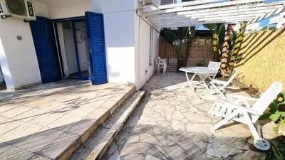 a patio with two chairs and a table at Boho Greek Haven with Orange Grove Views Near Beach in Larnaka