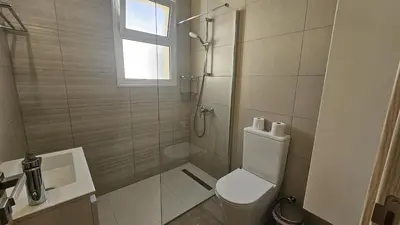 a bathroom with a shower and a toilet and a sink at STAY Local Apartment in Larnaka