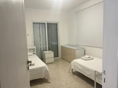 a white room with two beds and a mirror at Ayia Napa - Ayia Thekla Sea View Beach Villa in Ayia Napa