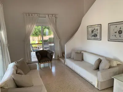 a living room with a couch and a chair at Ayia Napa - Ayia Thekla Sea View Beach Villa in Ayia Napa