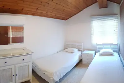 a bedroom with two beds and a sink in it at Ayia Napa - Ayia Thekla Sea View Beach Villa in Ayia Napa