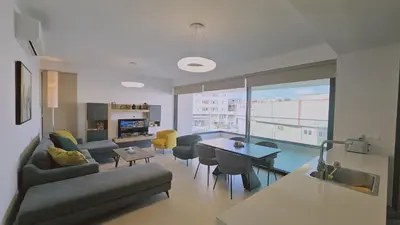 a living room with a couch and a table at STAY Diamond Apartment in Larnaka