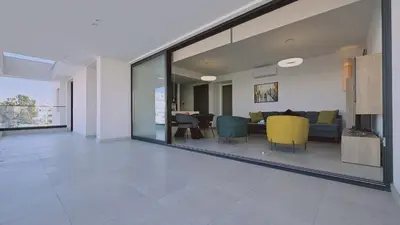 a living room with a couch and a dining room at STAY Diamond Apartment in Larnaka