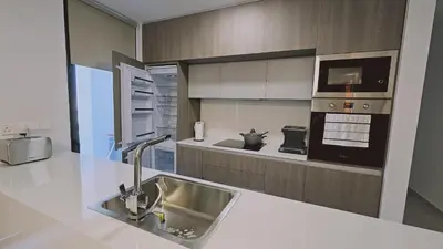 a kitchen with a sink and a microwave at STAY Diamond Apartment in Larnaka
