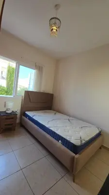 a bedroom with a bed in a room with a window at Villa Dafni Malama in Paralimni