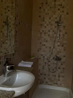 a bathroom with a sink and a shower at Maison Andre in Pano Lefkara