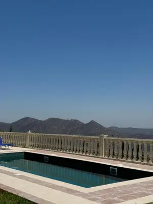 a swimming pool with mountains in the background at Maison Andre in Pano Lefkara