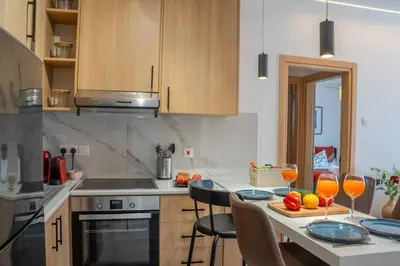 a kitchen with a table with two glasses of orange juice at Beautiful One Bedroom Apartment, 186 Meters to Beach, Central Location Next to Cafes & Bars in Limassol
