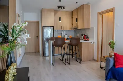 a kitchen with a table and chairs in a room at Beautiful One Bedroom Apartment, 186 Meters to Beach, Central Location Next to Cafes & Bars in Limassol