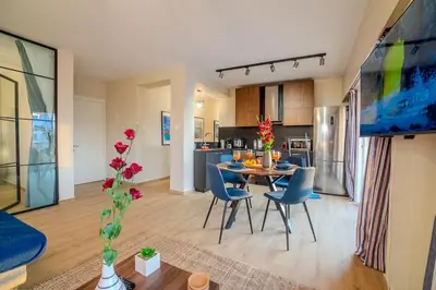 a living room and kitchen with a table and chairs at Two Bedroom Apartment, Spacious & Newly Renovated, Three Minutes from the Beach in Limassol