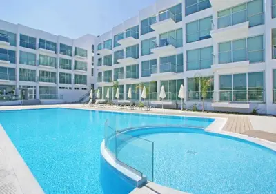 a large swimming pool in front of a building at Coralli Privileges Apt in Protaras