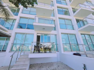a building with a balcony with a cow on it at Coralli Privileges Apt in Protaras
