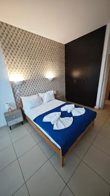 a bedroom with a bed with towels on it at Coralli Privileges Apt in Protaras