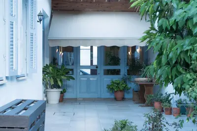 a blue door on a house with potted plants at ANANKE Home in Nicosia