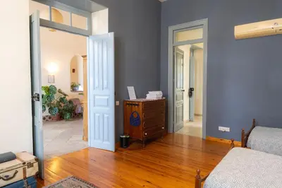 a bedroom with a bed and a dresser in a room at ANANKE Home in Nicosia