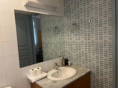 a bathroom with a sink and a mirror at ANANKE Home in Nicosia