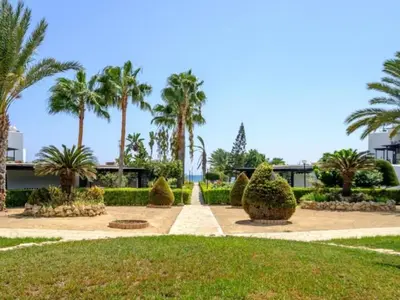 a park with palm trees and a walk way at Yialos Village by Cybarco in Larnaka