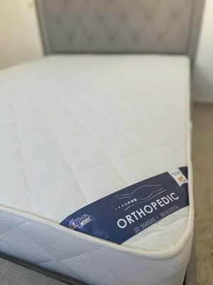a mattress with a box on top of it at Yialos Village by Cybarco in Larnaka